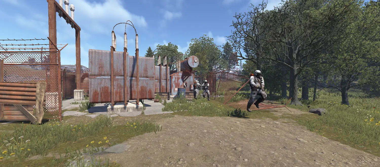 Four scientists in white suits advancing through a substation.