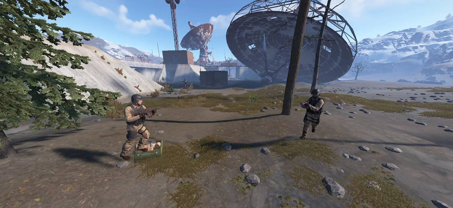 Two scientists in tan BDU gear guarding an open supply crate below the Satellite Dish.